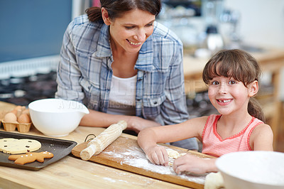 Buy stock photo Shot of a mother and daughter baking together