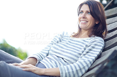Buy stock photo Shot of a beautiful woman lying on a hammock outdoors