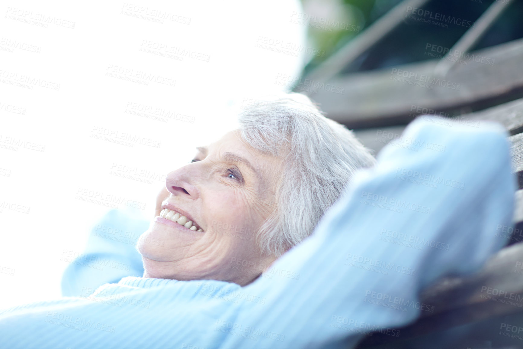 Buy stock photo Cropped shot of a senior woman lying on a hammock and enjoying the outdoors