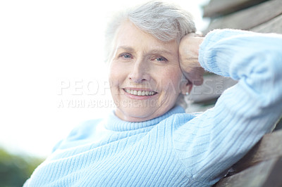 Buy stock photo Cropped shot of a senior woman lying on a hammock and enjoying the outdoors