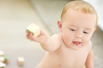 Buy stock photo Shot of an adorable little boy wearing his diaper while playing with his blocks