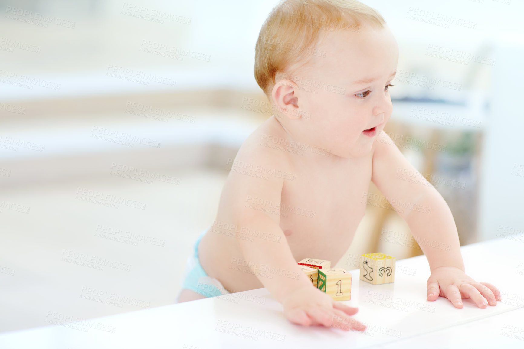 Buy stock photo Shot of an adorable little boy wearing his diaper while playing with his blocks