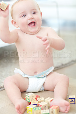 Buy stock photo Shot of an adorable little boy wearing his diaper while playing with his blocks