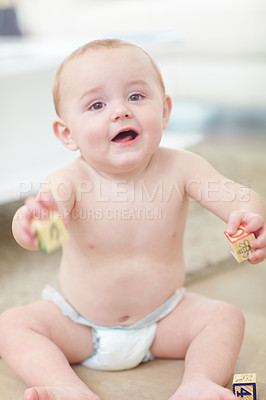 Buy stock photo Shot of an adorable little boy wearing his diaper while playing with his blocks