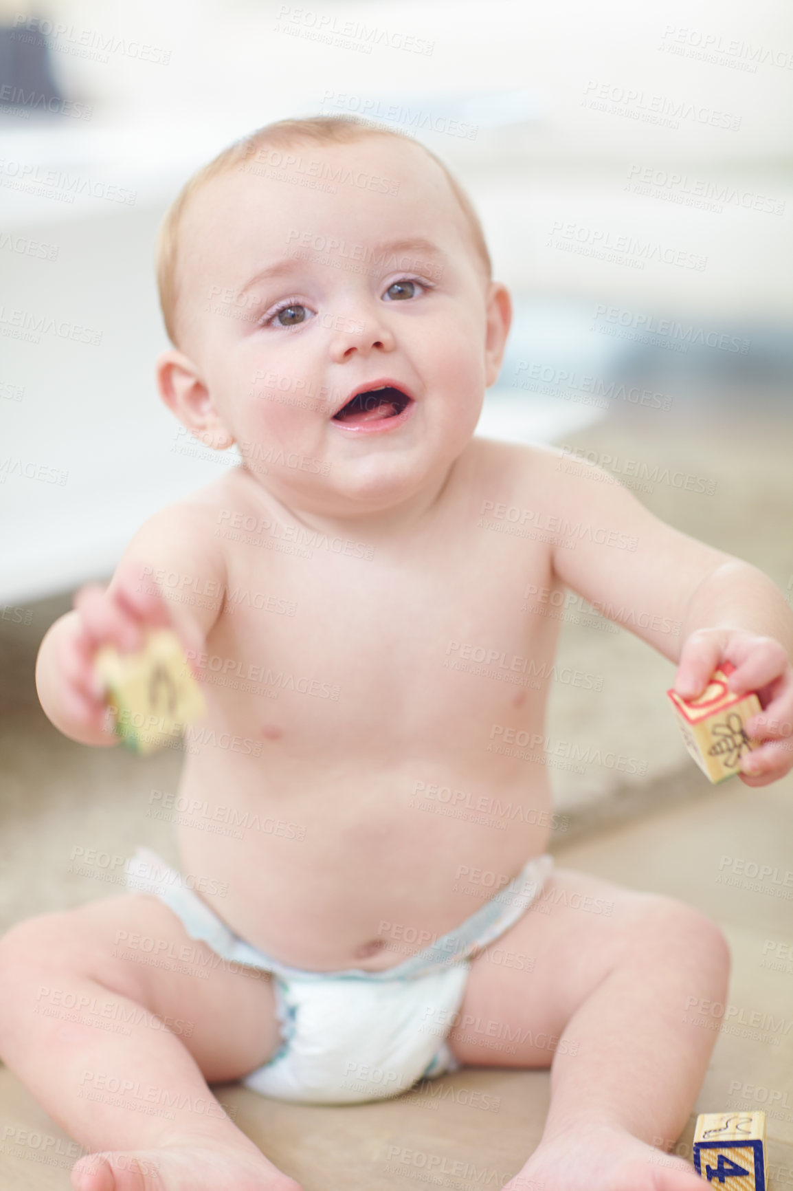 Buy stock photo Shot of an adorable little boy wearing his diaper while playing with his blocks