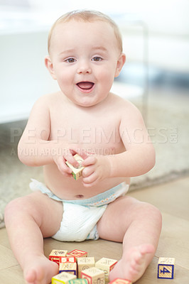 Buy stock photo Portrait of an adorable little boy wearing his diaper while playing with his blocks