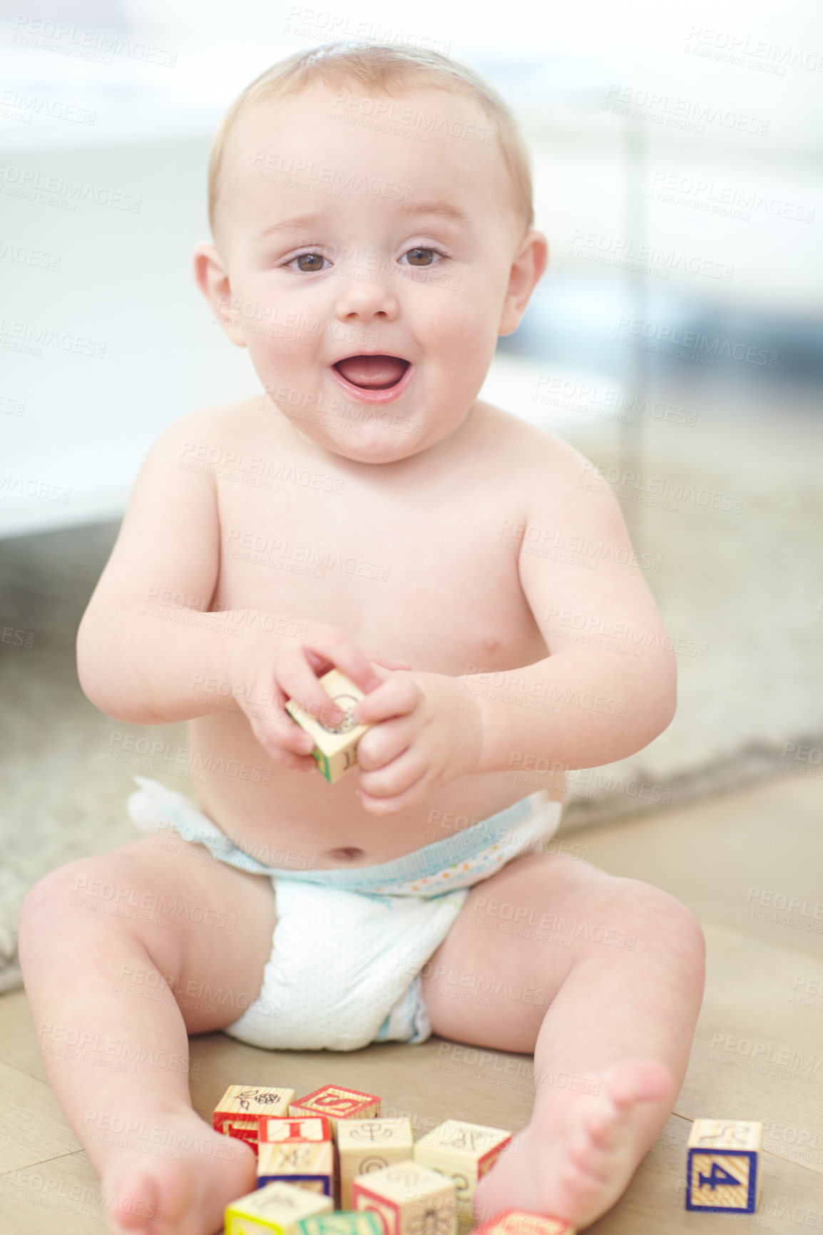 Buy stock photo Portrait of an adorable little boy wearing his diaper while playing with his blocks