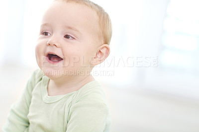 Buy stock photo Shot of an adorable little boy sitting on the floor