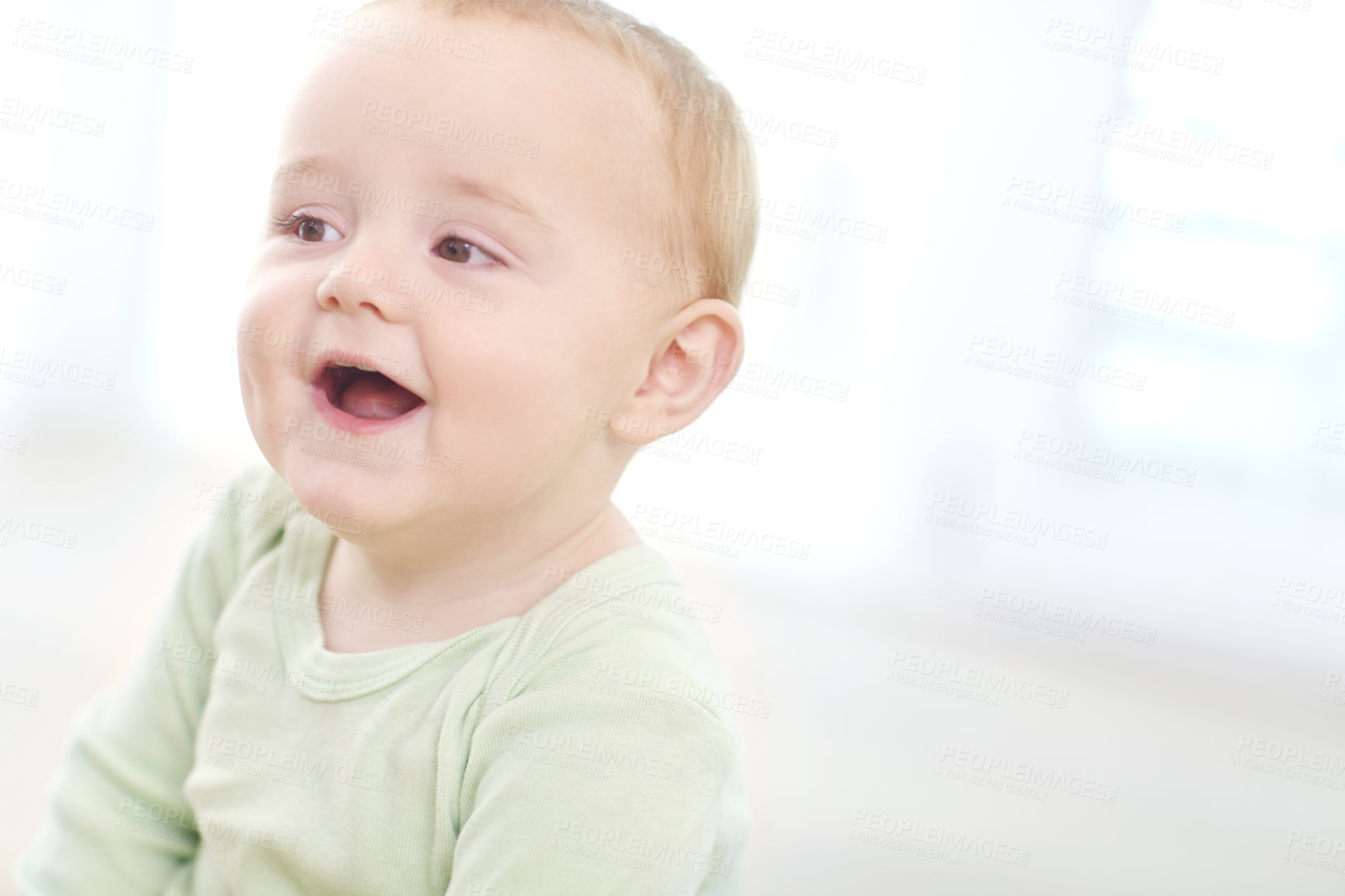 Buy stock photo Shot of an adorable little boy sitting on the floor