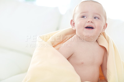 Buy stock photo Shot of a cute little baby boy wrapped in his blanket