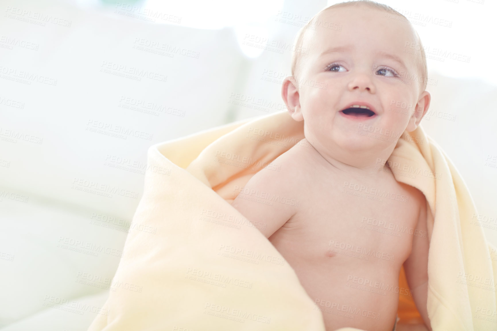 Buy stock photo Shot of a cute little baby boy wrapped in his blanket