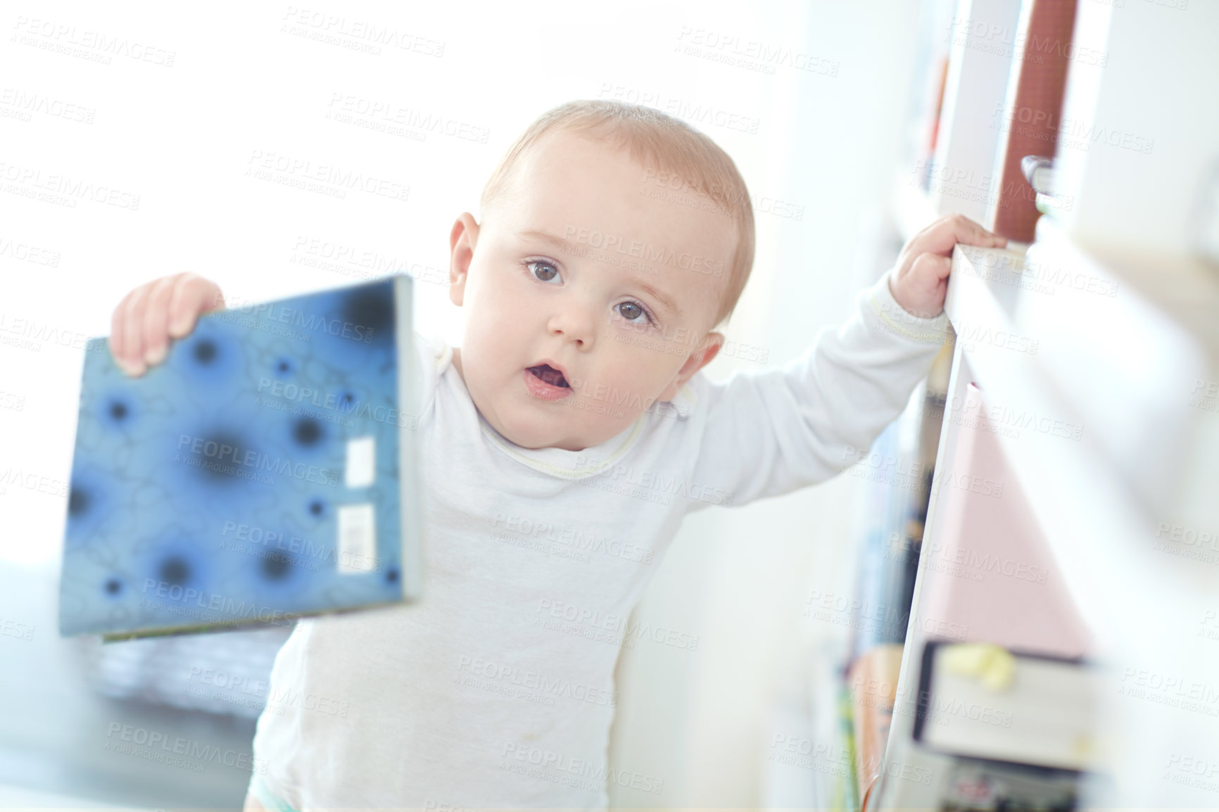 Buy stock photo Shot of an adorable little boy holding a book