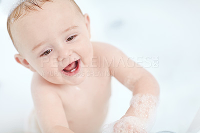 Buy stock photo Shot of a cute baby boy standing in the bathtub