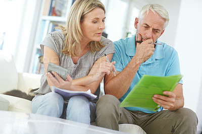 Buy stock photo Shot of a mature couple working with their home finances