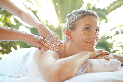 Buy stock photo Shot of an attractive mature woman enjoying a massage at a day spa