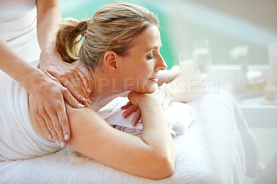 Buy stock photo Shot of an attractive mature woman getting a massage at a day spa