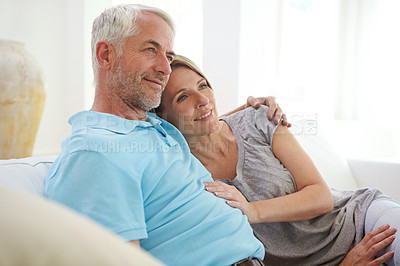 Buy stock photo Old couple, hug and thinking about future in retirement at home or love, care and support. Commitment of man and woman in healthy marriage with trust, life insurance and security on living room couch