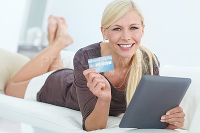 Buy stock photo Portrait of a beautiful woman doing some online shopping at home using her digital tablet