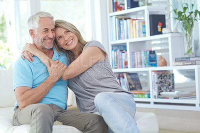 Buy stock photo Shot of an affectionate mature couple relaxing on the sofa at home