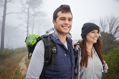 Buy stock photo Shot of a handsome young man on a hike with his girlfriend