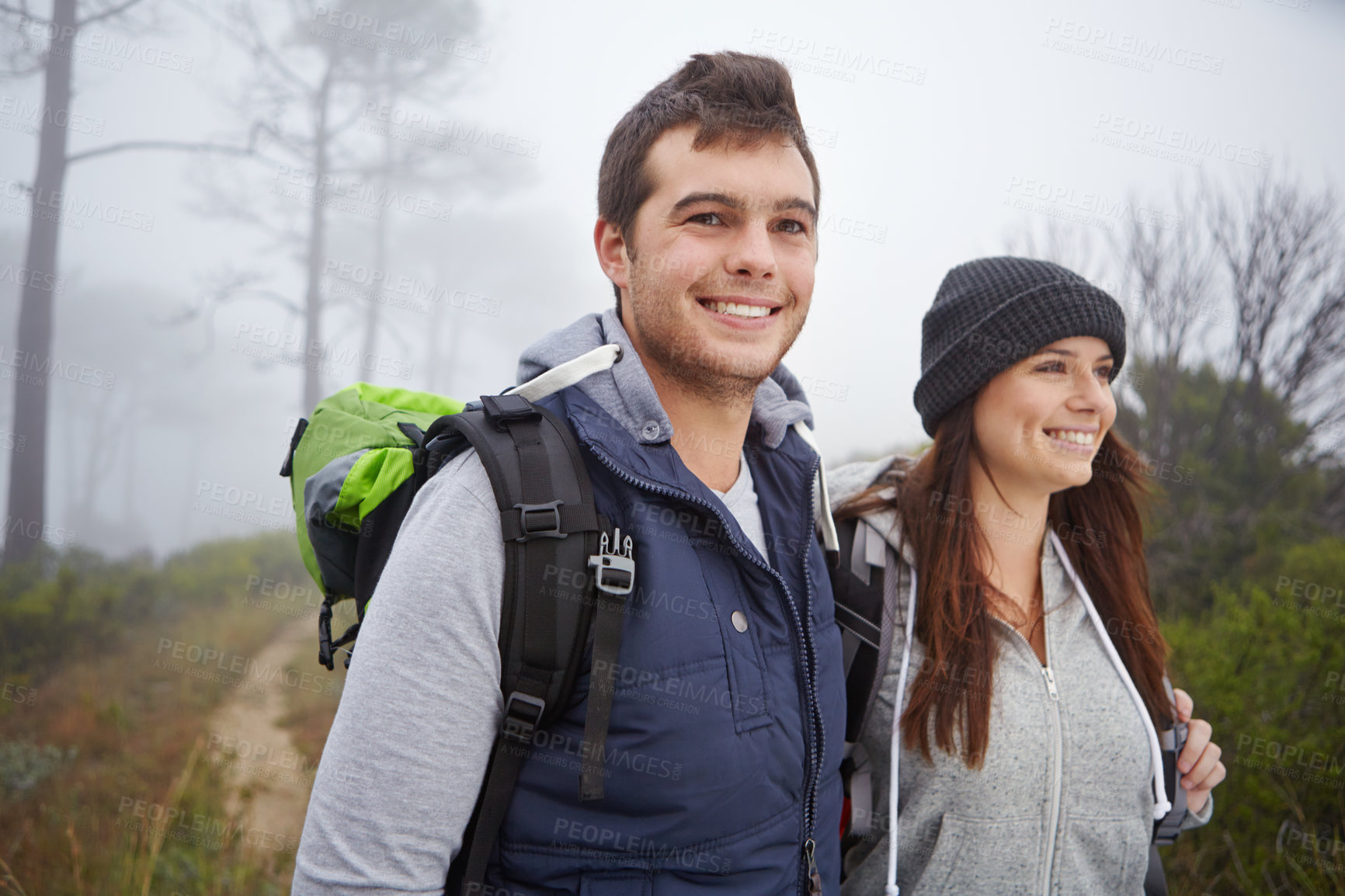 Buy stock photo Shot of a handsome young man on a hike with his girlfriend