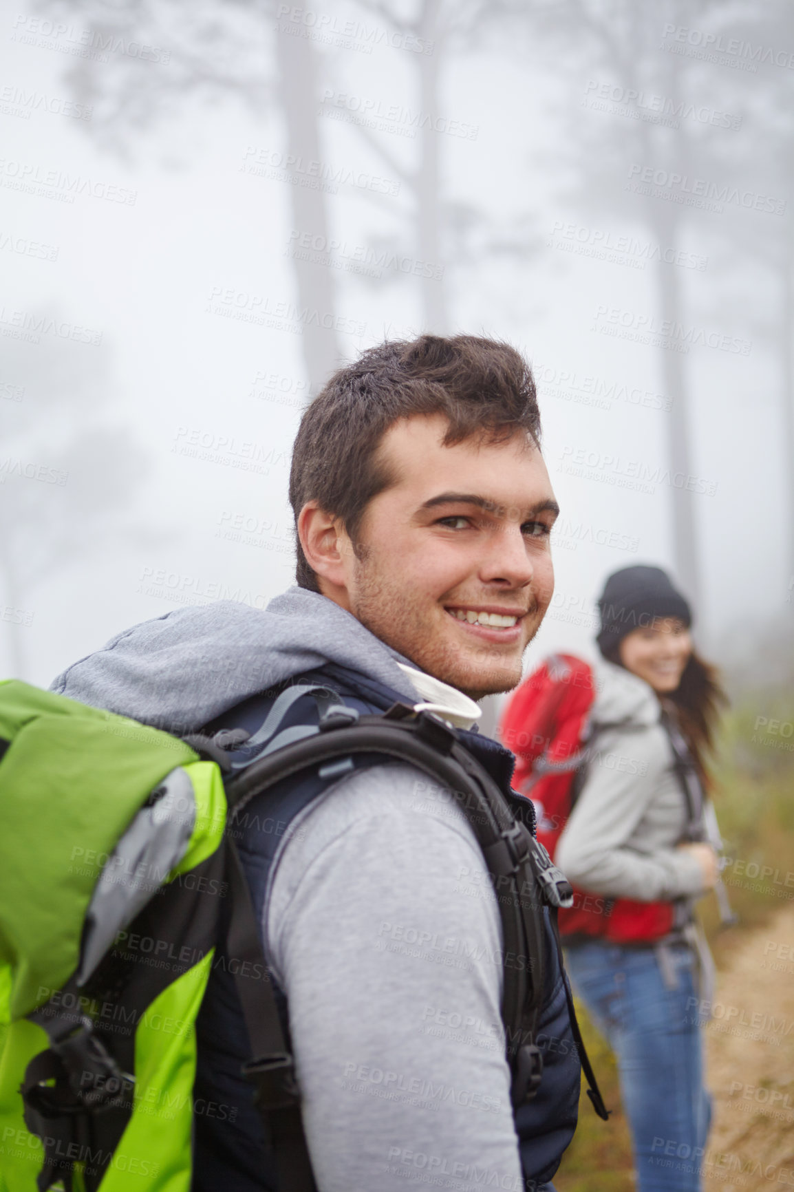 Buy stock photo Portrait of a handsome young man on a hike with his girlfriend