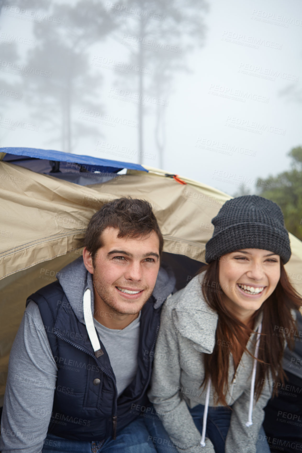 Buy stock photo Shot of a young couple enjoying their camping trip