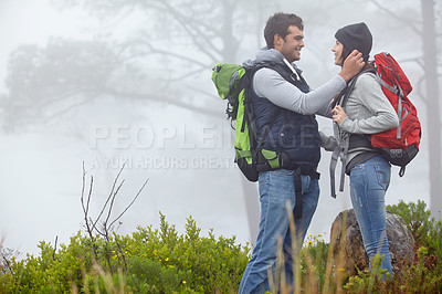 Buy stock photo Shot of a loving young couple being affectionate while on a hike