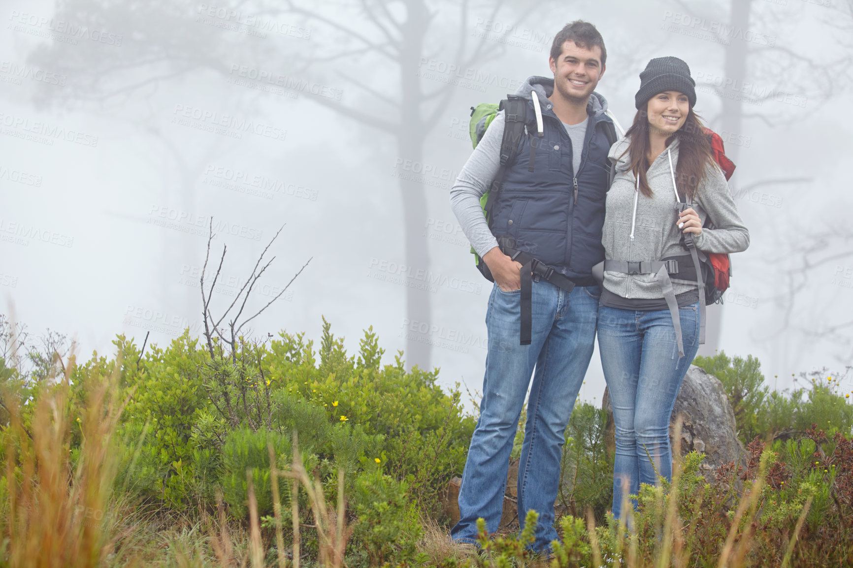 Buy stock photo Shot of a young couple enjoying a hike through nature