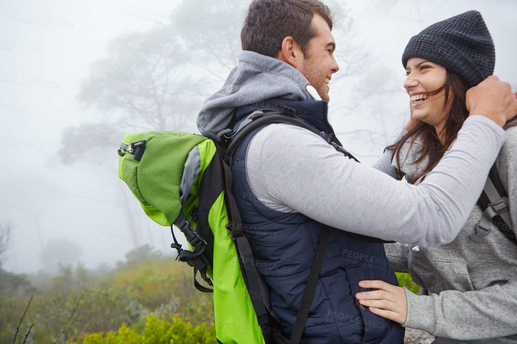 Buy stock photo Shot of a loving young couple being affectionate while out on a hike