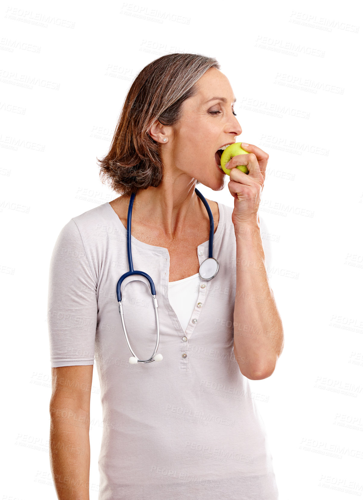 Buy stock photo Woman, doctor and biting apple in studio with confidence for diet and nutrition on white background. Female person, dietitian and fruit or healthy food for healthcare, wellness and self care