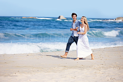 Buy stock photo Couple, walking or happy on beach for love, travel or laugh on summer vacation. Woman, man or holding arm at ocean with joke, funny story or share relationship memories on holiday with comedy in Bali