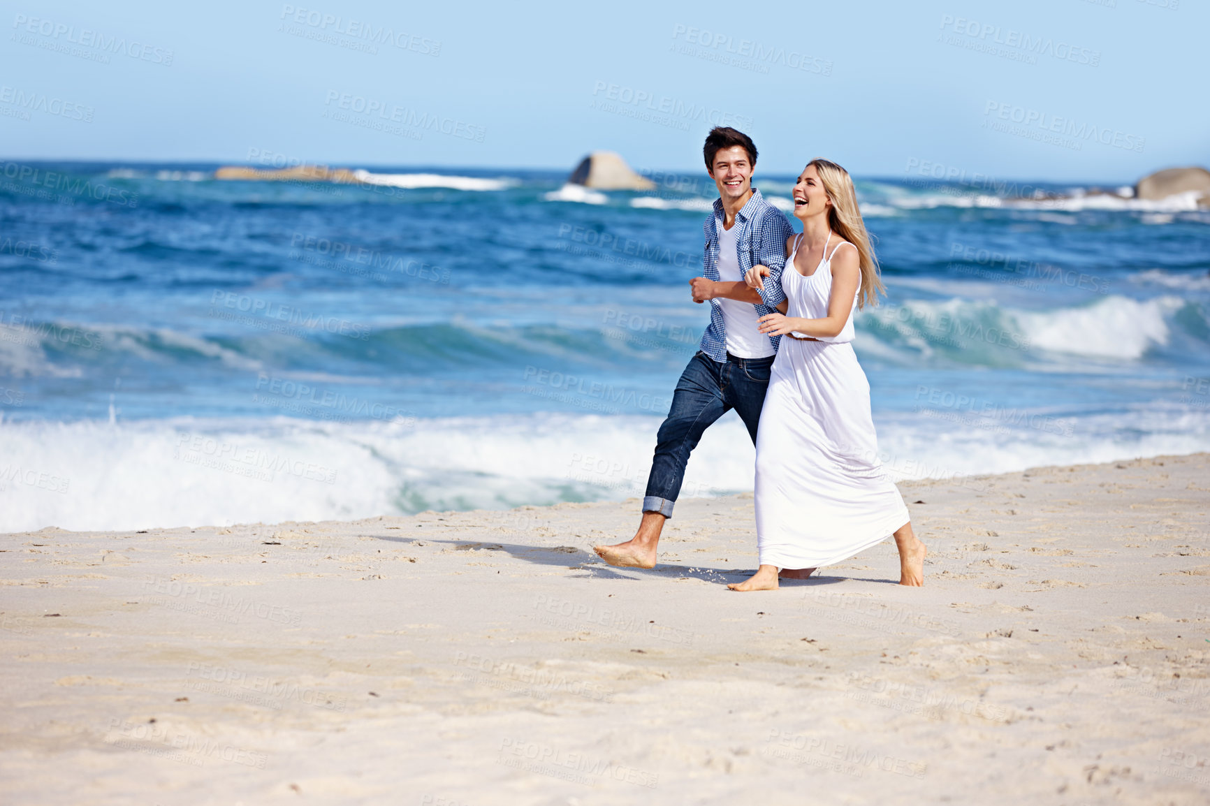 Buy stock photo Couple, walking or happy on beach for love, travel or laugh on summer vacation. Woman, man or holding arm at ocean with joke, funny story or share relationship memories on holiday with comedy in Bali