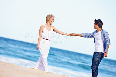 Buy stock photo Couple, holding hands or dance on beach for love, travel or summer vacation. Happy woman, man or romance at ocean for trust, commitment or security in relationship on holiday with sky space in Bali