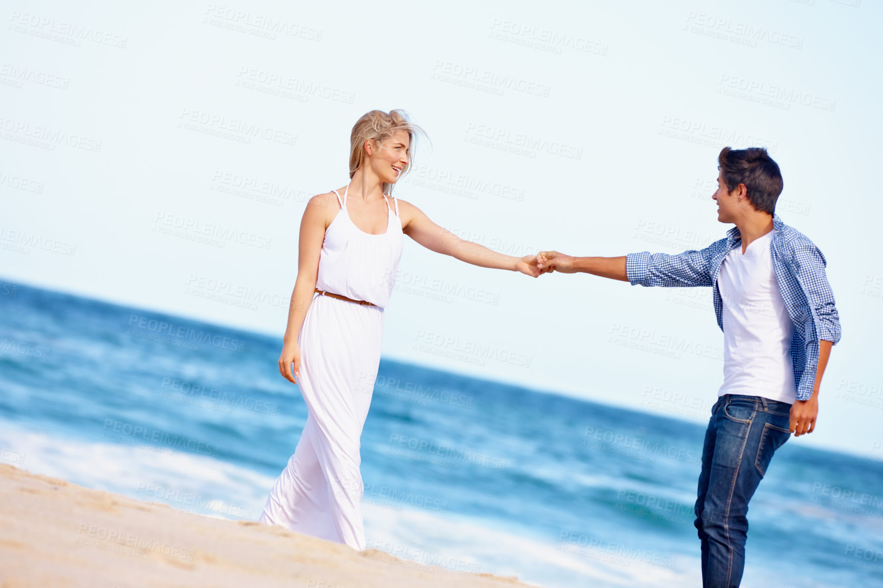 Buy stock photo Couple, holding hands or dance on beach for love, travel or summer vacation. Happy woman, man or romance at ocean for trust, commitment or security in relationship on holiday with sky space in Bali