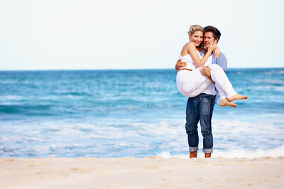 Buy stock photo Portrait of a happy young couple enjoying a romantic day on the beach