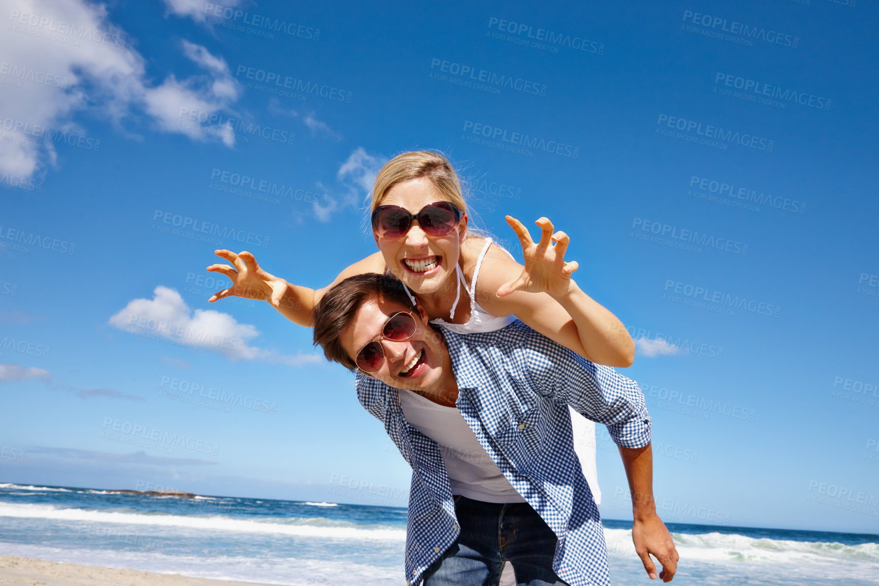 Buy stock photo Beach, piggyback and fun for couple, playing and celebration of commitment, bonding and happy in relationship. Outdoor, man and woman on holiday, waves and together in nature, goofy and date at sea