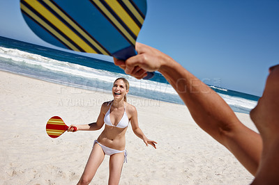 Buy stock photo Couple, tennis and beach play by waves together for fun, holiday or bonding with sports and exercise in nature. Happy people, game and Miami ocean with vacation, adventure and travel with trip