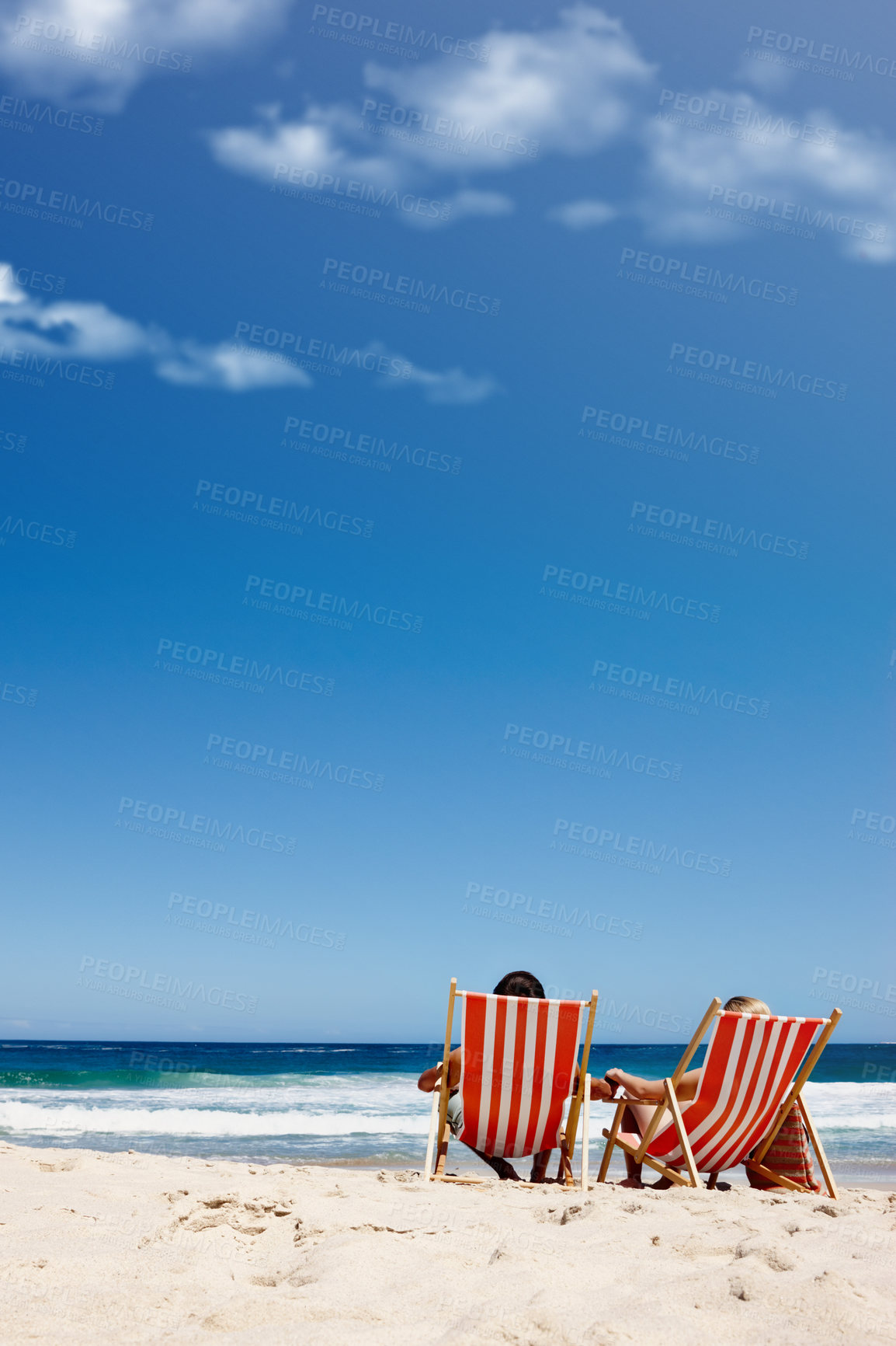 Buy stock photo Back view, chair or couple at sea with space to relax on vacation, valentines day or holiday. Sunbathe, mockup or people at beach for bonding or tanning at ocean on romantic trip on island in Greece