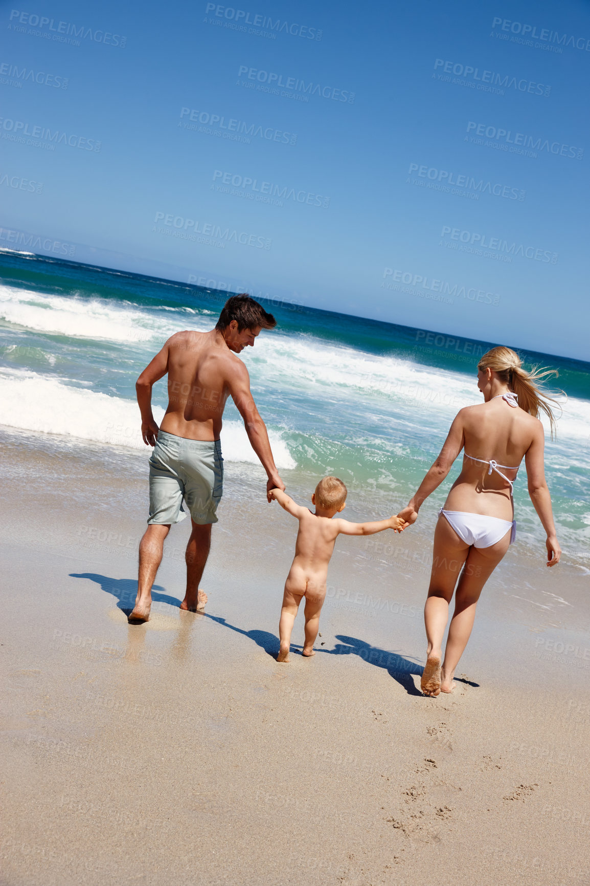 Buy stock photo Happy family, holding hands and beach with baby for summer holiday, weekend or bonding in nature. Mother, father and toddler or kid walking with parents on ocean coast for fun outdoor vacation by sea