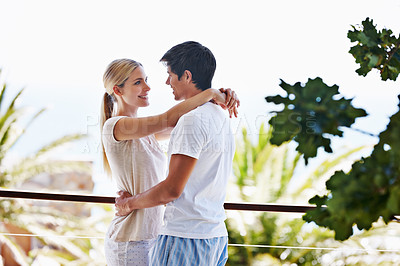 Buy stock photo Balcony, couple and love with hug for bonding, connection and commitment with smile in relationship. Outside, man and woman with embrace for dating, support and admiration with trust on vacation