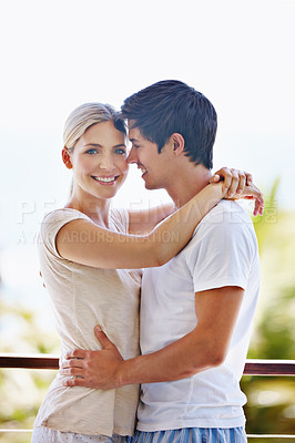 Buy stock photo Balcony, couple and portrait with hug for love, bonding or commitment with trust in healthy relationship. Outside, man and woman with smile for dating, support or romantic with connection on vacation