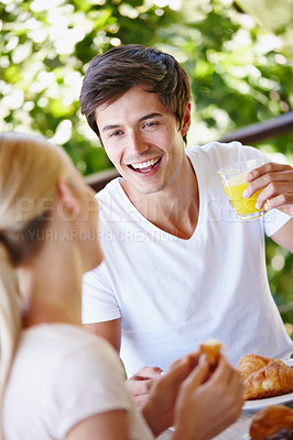 Buy stock photo Balcony, couple and morning with juice for breakfast, hungry and bonding together with connection. Food, happy man and woman with nutrition for eating, romance and commitment with smile on vacation