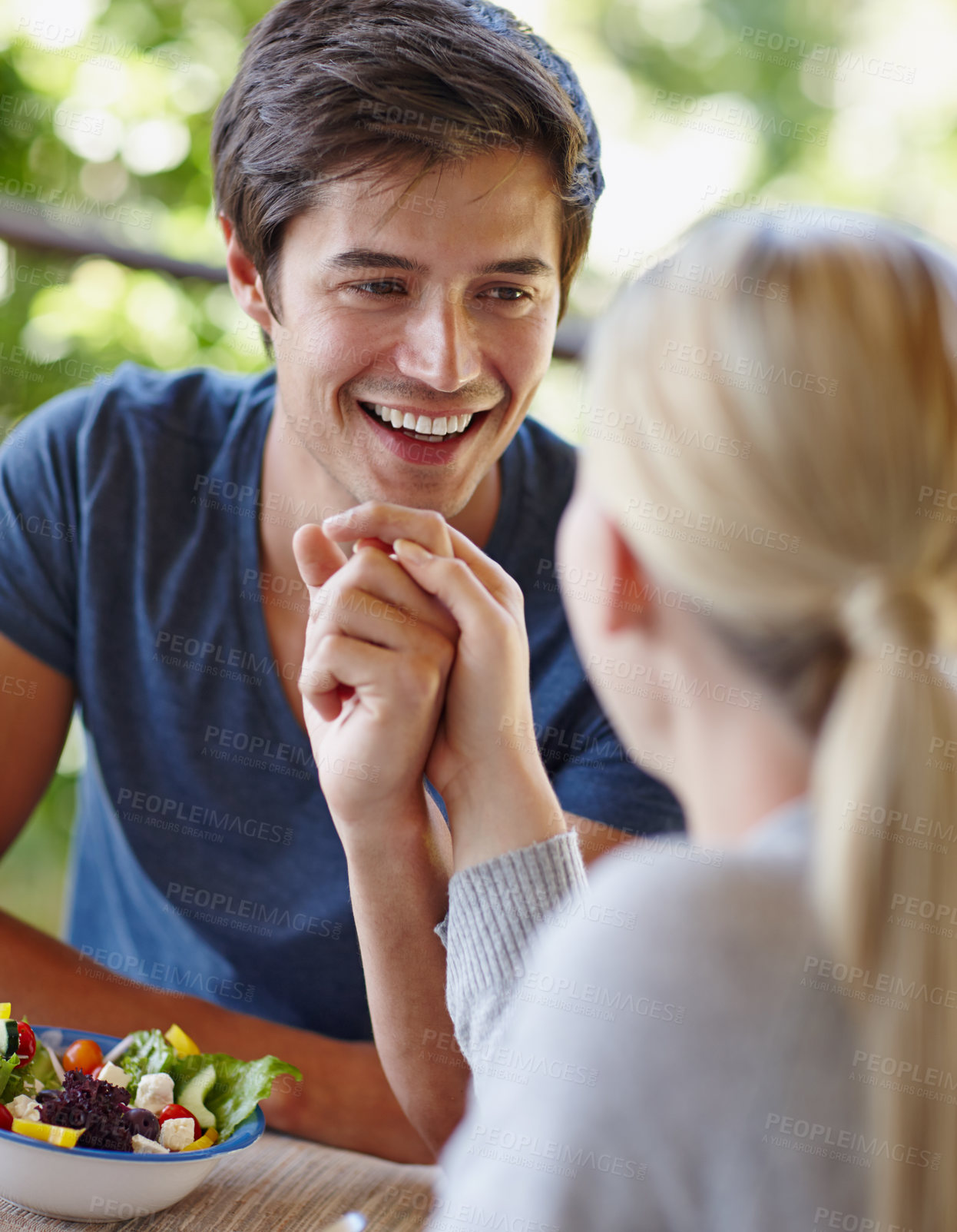 Buy stock photo Happy, couple and holding hands with food on home balcony with salad, lunch and outdoor date. Man, smile and love with eating, wellness and care together with nutrition on patio with romance on table