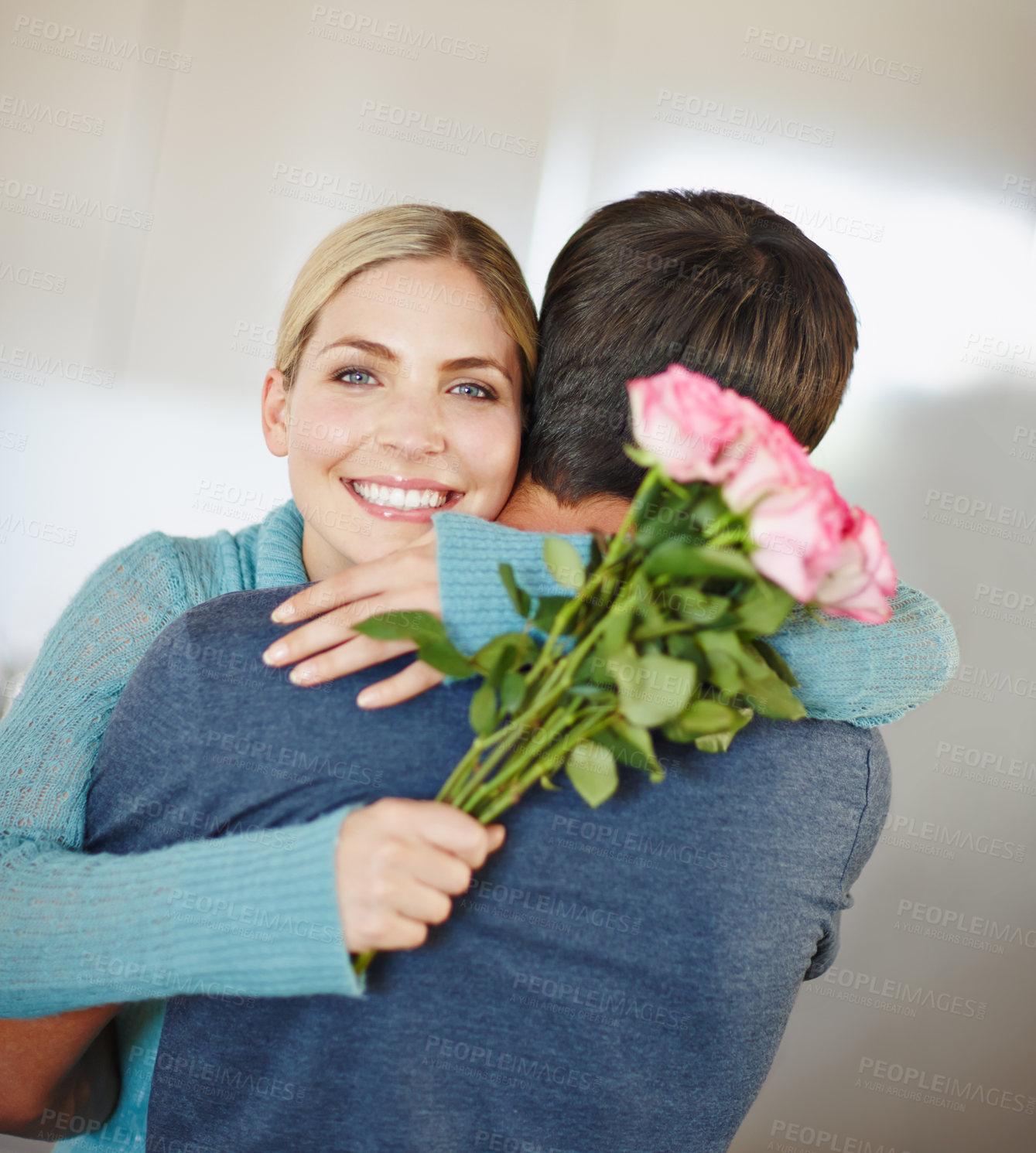 Buy stock photo Portrait, hug and couple with flowers, bonding and appreciation to partner, happy and smile in home. Embrace, man and woman with bouquet, gift and romance on valentines day, date and celebration