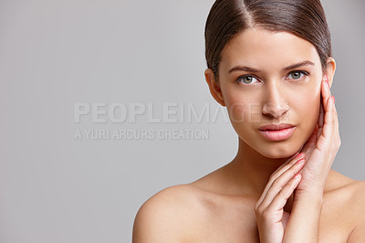 Buy stock photo Studio portrait of a beautiful young woman touching her flawless skin