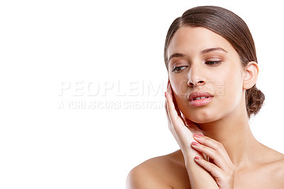 Buy stock photo Studio shot of a beautiful young woman touching her flawless skin
