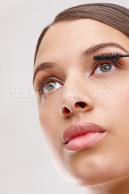 Buy stock photo Woman, mascara and brush for lashes in studio, closeup or low angle for beauty by white background. Girl, person and model with tools for eye makeup application with cosmetics, glow or transformation