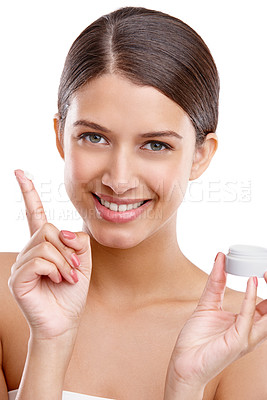 Buy stock photo Studio portrait of a beautiful young woman showing the moisturizer she uses