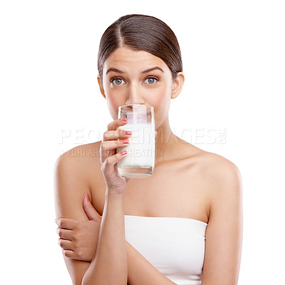 Buy stock photo Studio portrait of an attractive young woman drinking a glass of milk